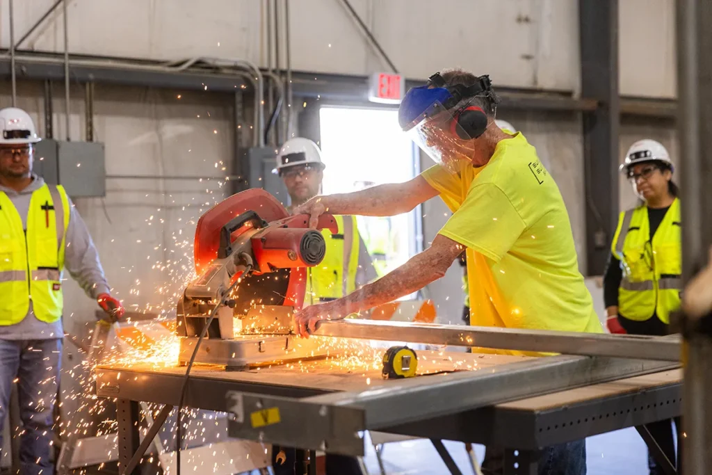 Man in Warehouse Cutting Metal