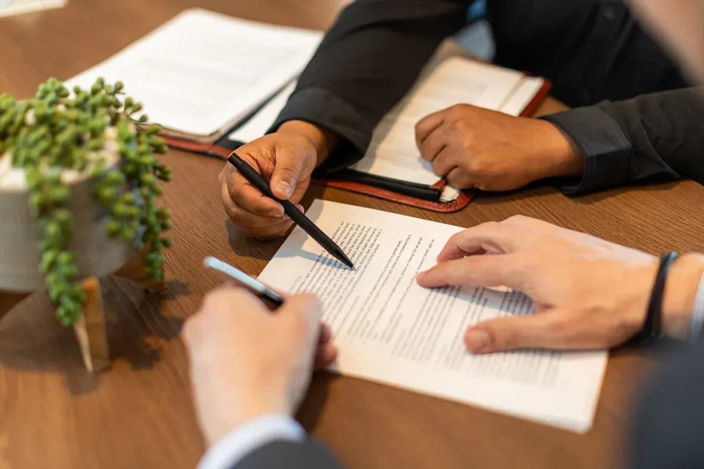 Two People Reviewing Documents at Desk